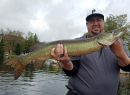 Junior with nice spring muskie while smallie fishing